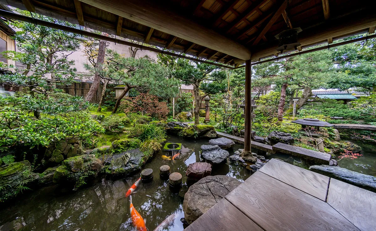 The preserved interior of the Nomura Family Samurai House in Kanazawa showing original cypress ceilings and gold-leaf fusuma screen paintings