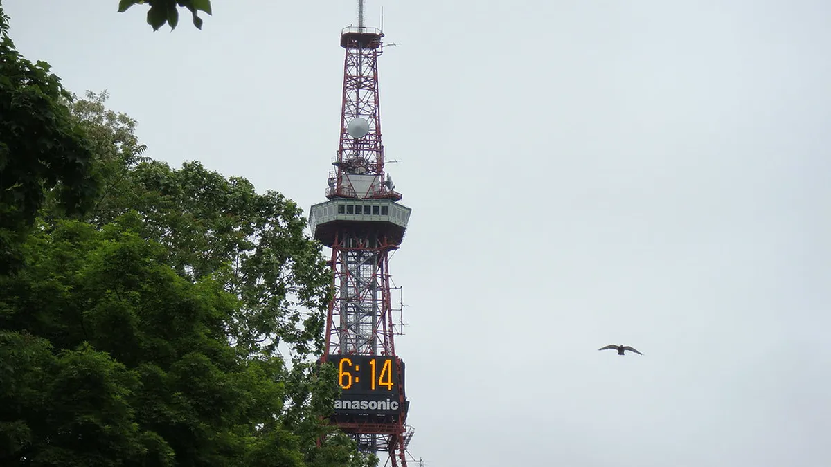 Sapporo TV Tower rising above Odori Park's wide green lawns and tree-lined pathways in central Sapporo Japan