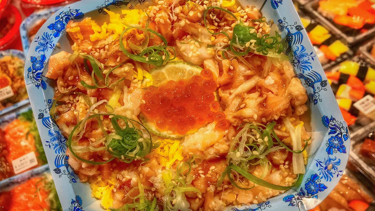 A vibrant kaisendon seafood rice bowl topped with fresh sashimi and roe, the signature dish of Japan's coastal fish markets