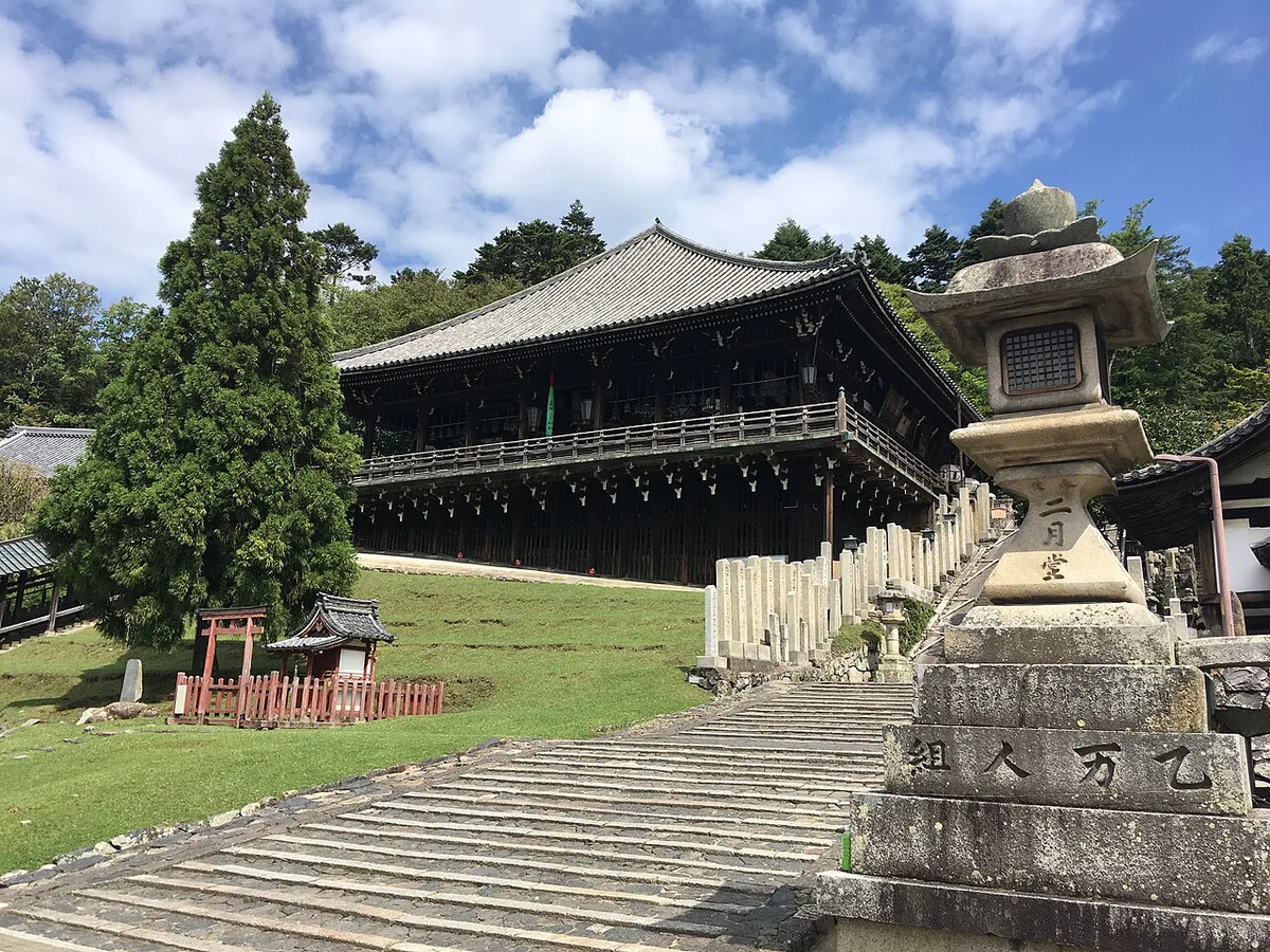 Monks swinging a flaming otaimatsu torch from Nigatsu-do hall during Omizutori at Todai-ji, Japan — 2