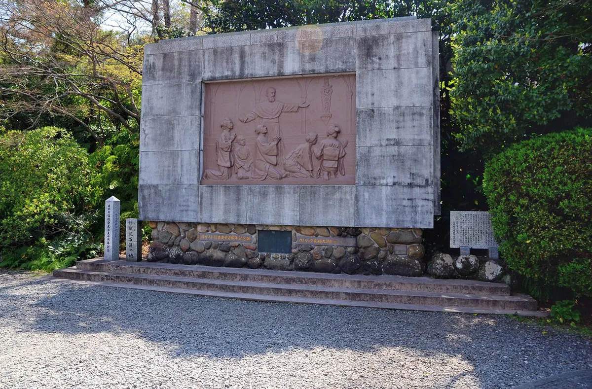 Oura Church Gothic spire and white stucco facade rising above the Minamiyamate hillside in Nagasaki, Japan