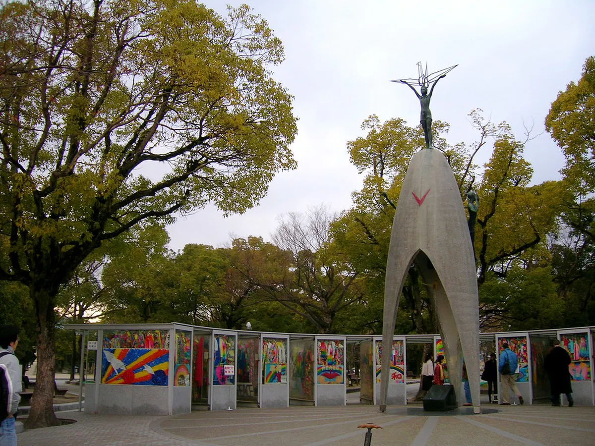 Children's Peace Monument at Hiroshima Peace Memorial Park surrounded by chains of colorful paper cranes from Japan and worldwide