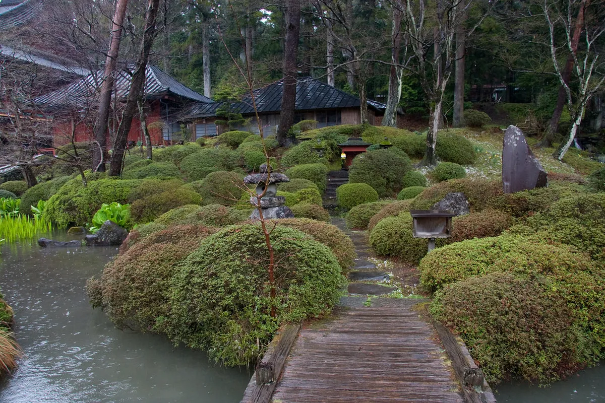 Shoyoen Garden at Rinnoji Temple in Nikko, a tranquil stroll garden with central pond and stone lanterns surrounded by maple trees