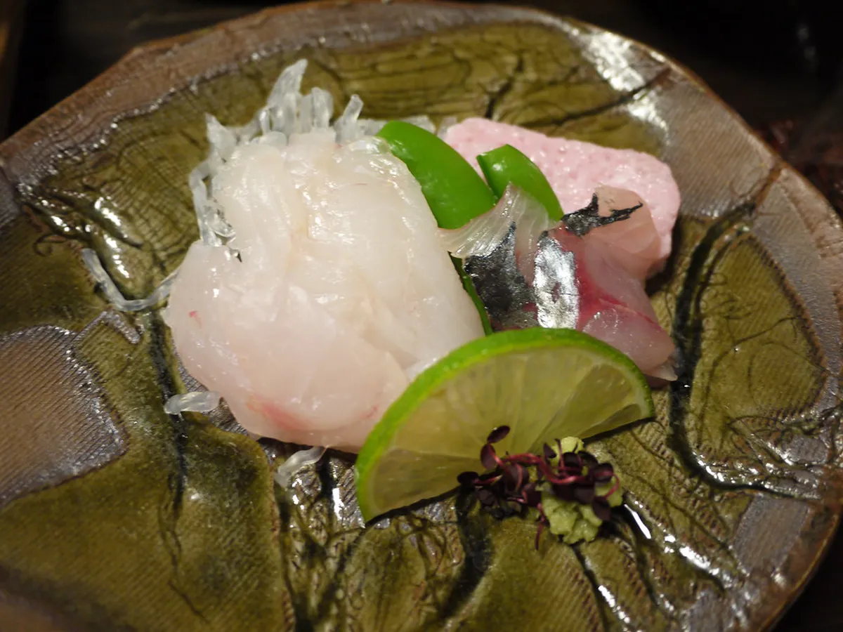 Beautifully arranged multi-course Kaiseki dinner served on lacquerware dishes at a traditional Japanese ryokan