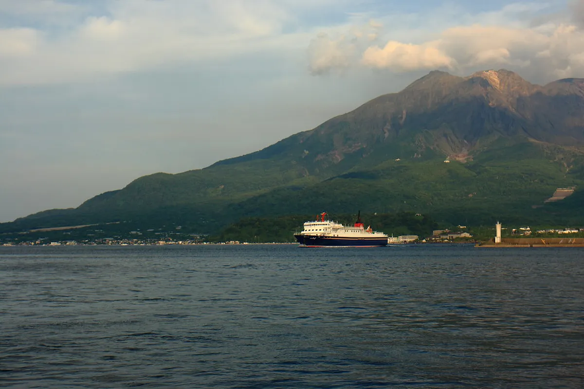Sakurajima ferry crossing Kinko Bay with the active volcano rising above the Kagoshima coastline