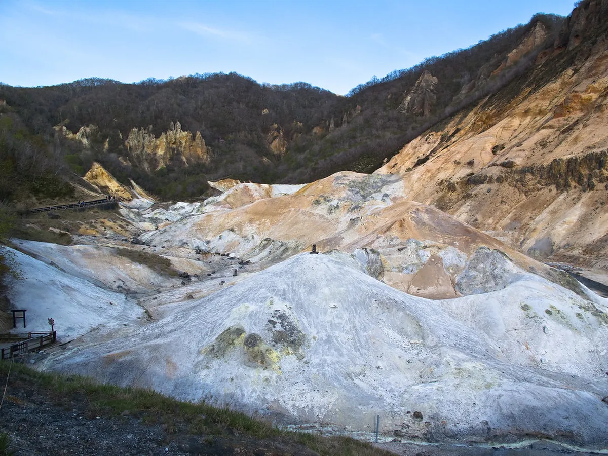 Noboribetsu Hell Valley in Hokkaido with steaming volcanic vents and sulfurous hot springs in a dramatic landscape