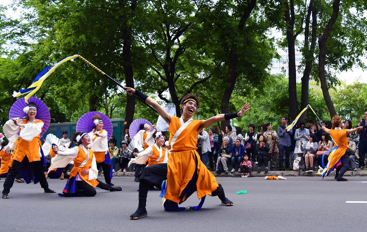 YOSAKOI Soran Festival performers in colorful traditional costumes dancing energetically through the streets of Sapporo Japan