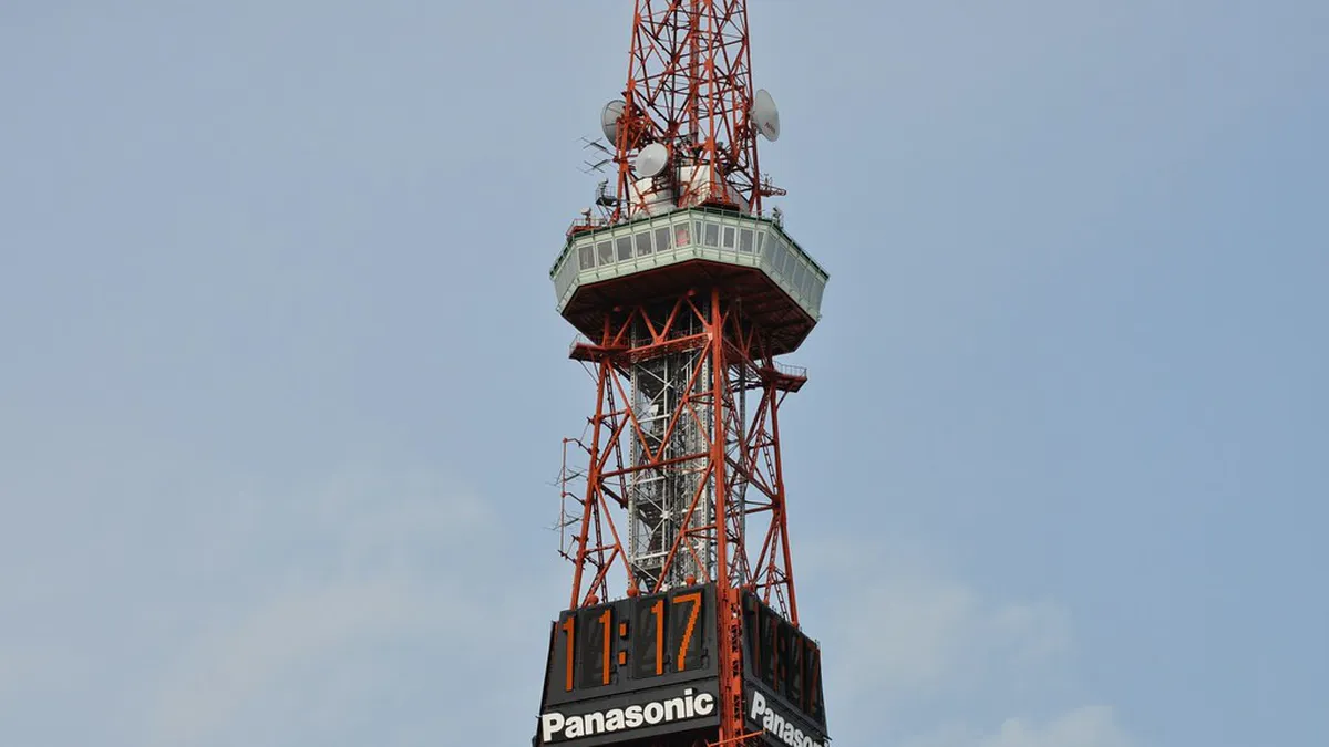 Sapporo TV Tower red landmark at the eastern end of Odori Park looking west across the city grid in Hokkaido Japan