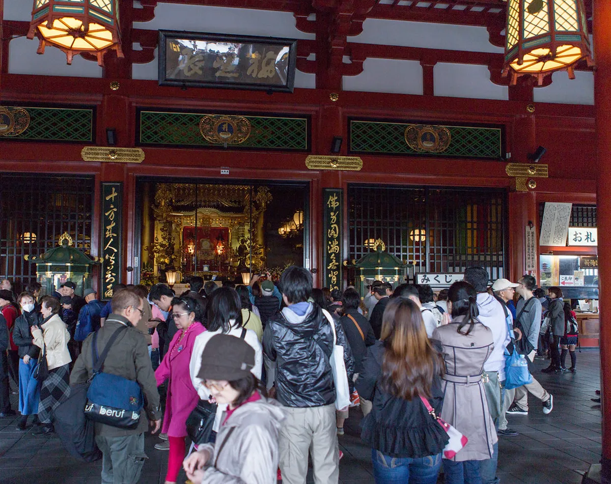 Senso-ji Hondo main hall with gold altars and incense smoke in Asakusa, Tokyo, Japan