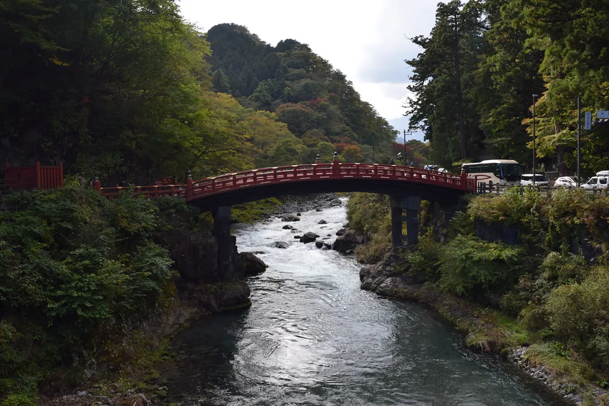 Shinkyo Bridge arching over the Daiya River in Nikko, the sacred vermillion lacquered structure marking the entrance to the UNESCO World Heritage site