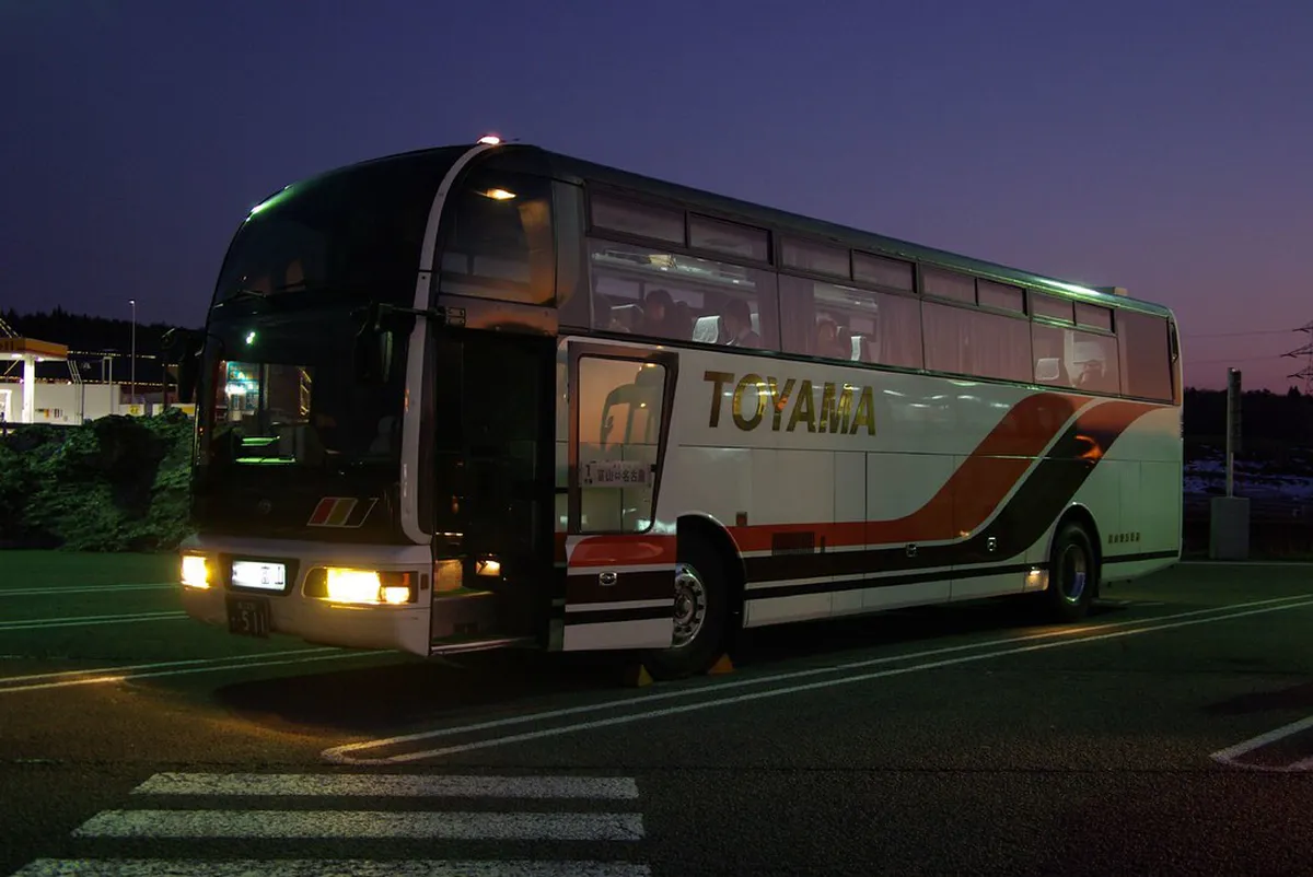 Shirakawa-go express highway bus departing from Gifu, Japan with scenic mountain backdrop