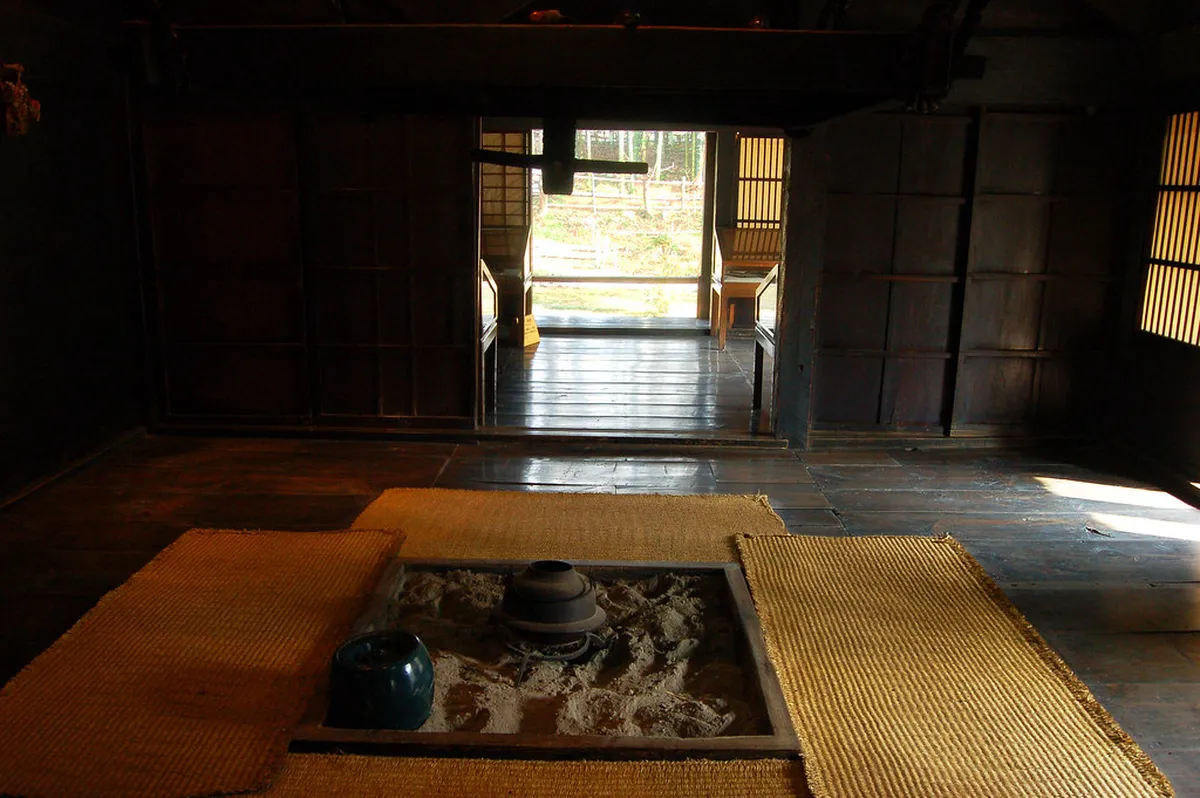 Interior of a Shirakawa-go gassho farmhouse showing traditional wooden beams and tatami room layout