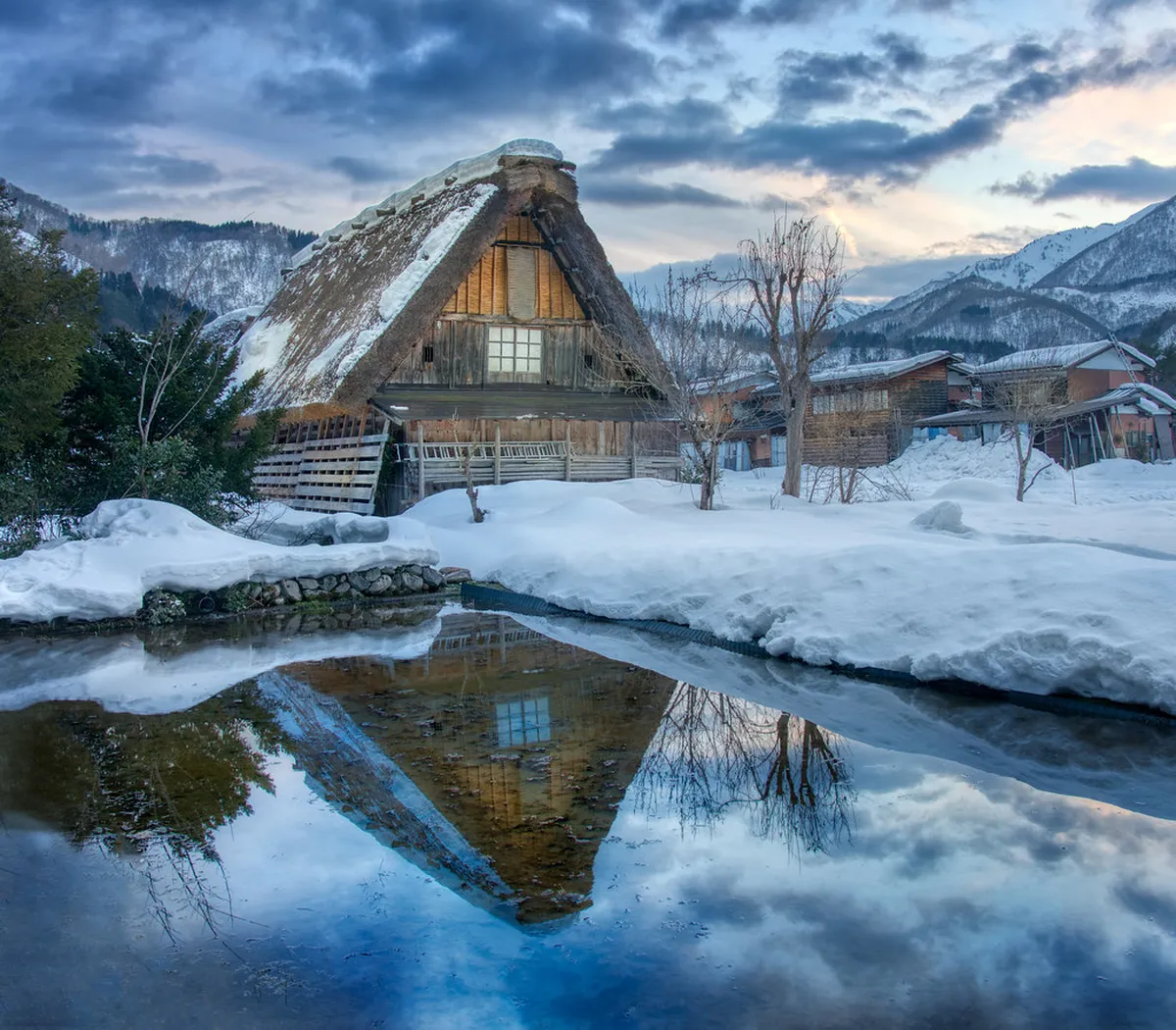 Snow-covered gassho-zukuri farmhouses in Shirakawa-go blanketed by winter snowfall in Japan