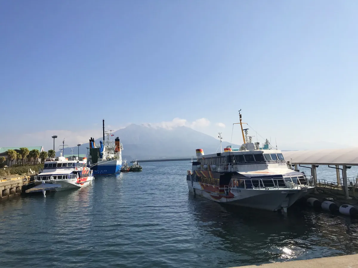 Kagoshima bay view with turquoise water and the silhouette of Sakurajima volcano rising across the water in southern Japan