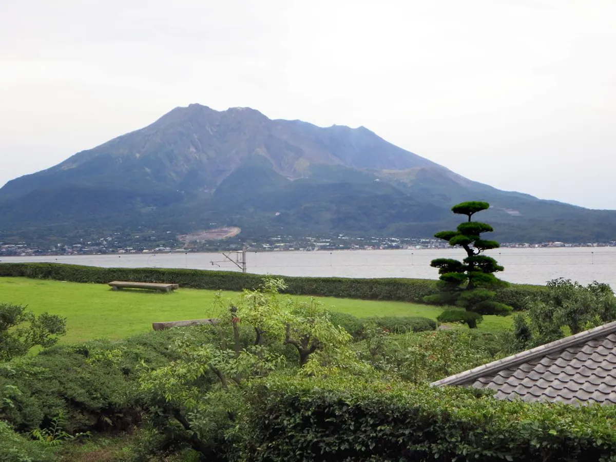 Sakurajima volcano rising above Kinko Bay as seen from Shiroyama Observatory in Kagoshima on a clear winter morning