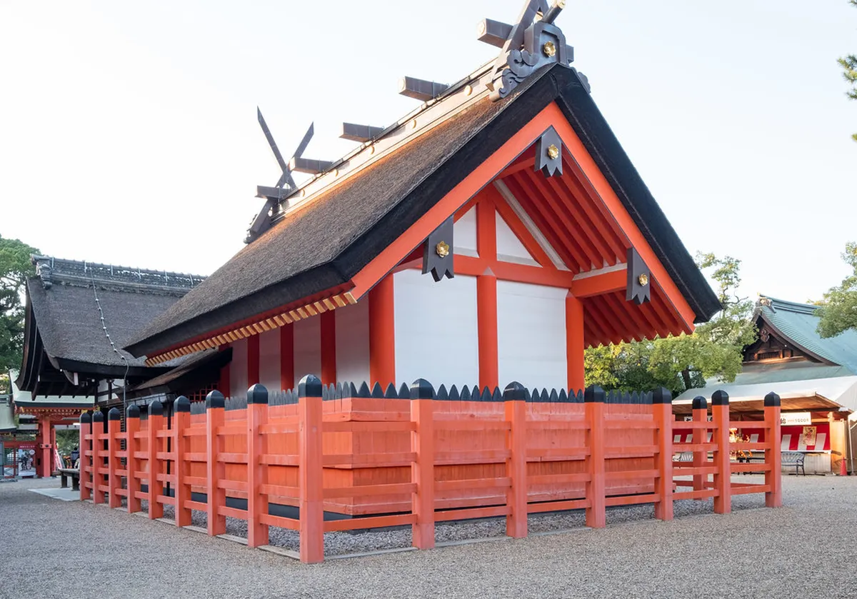 Sumiyoshi Taisha shrine grounds with traditional thatched-roof halls and stone lanterns in Osaka, Japan