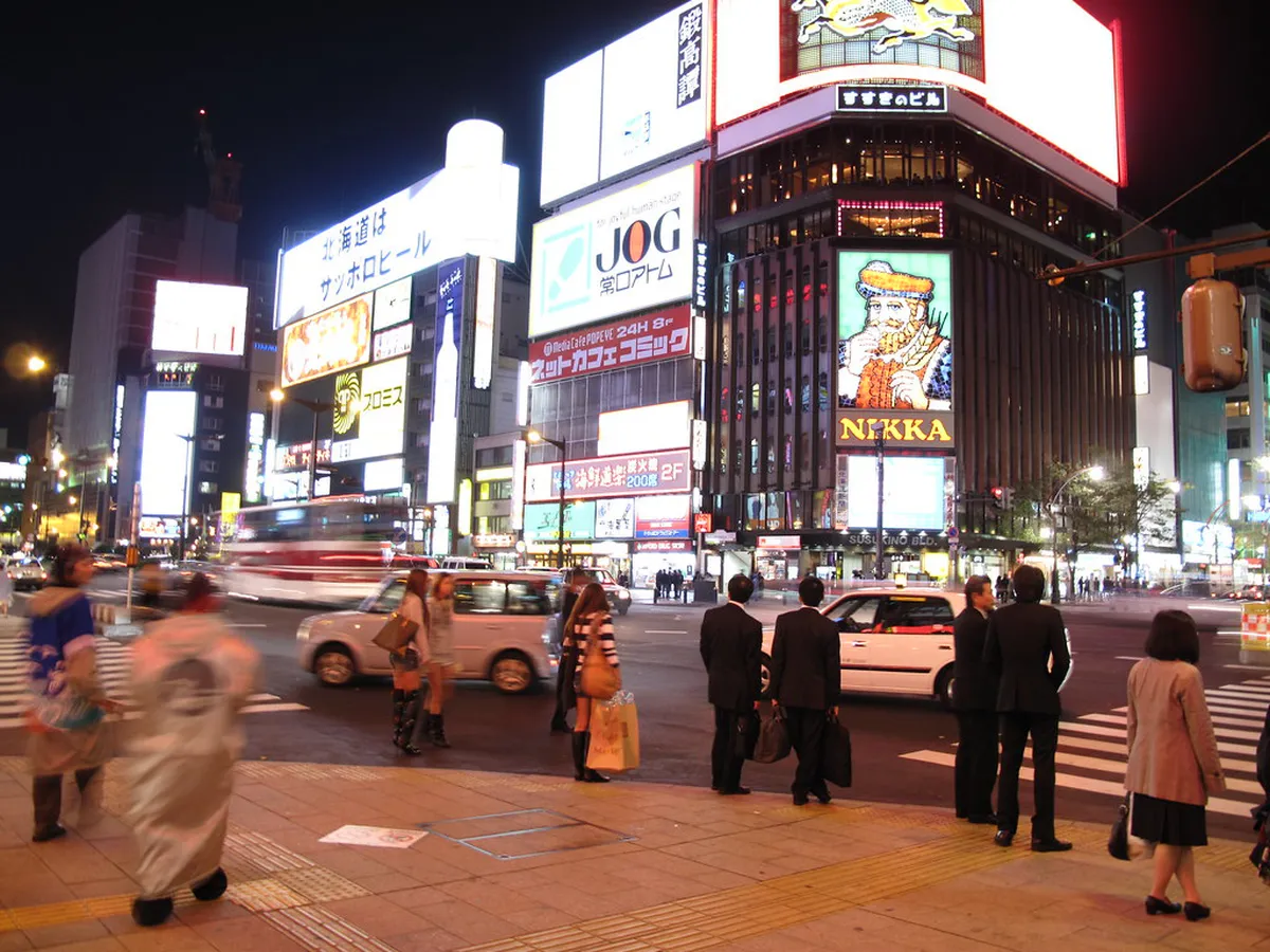 Susukino entertainment district at night with neon signs and bright lights illuminating the streets of central Sapporo Japan