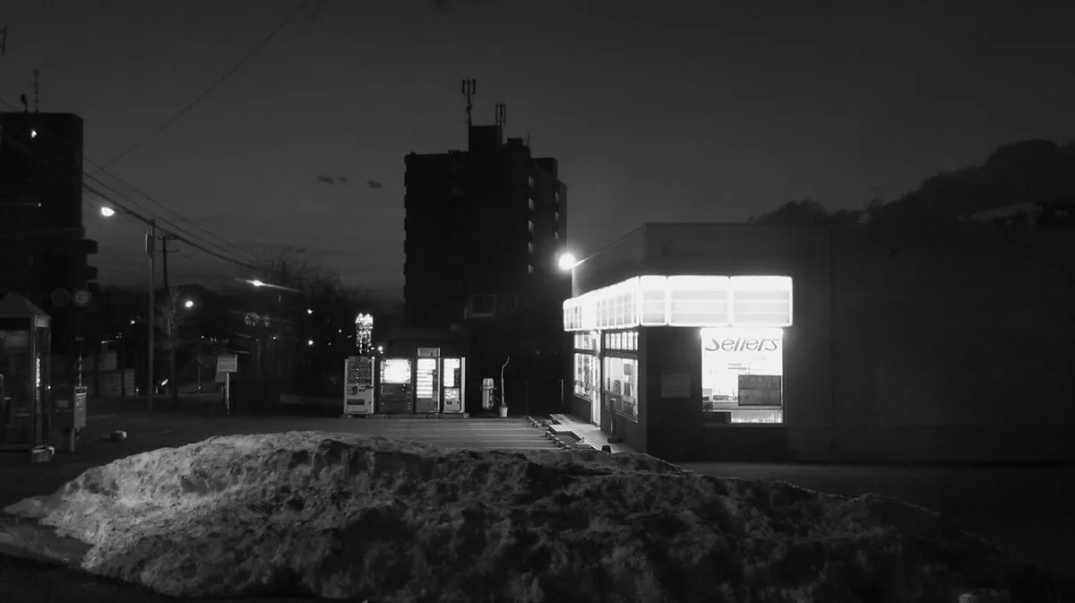 Busy Sapporo street at night with illuminated storefronts and pedestrians near Susukino in Hokkaido, Japan
