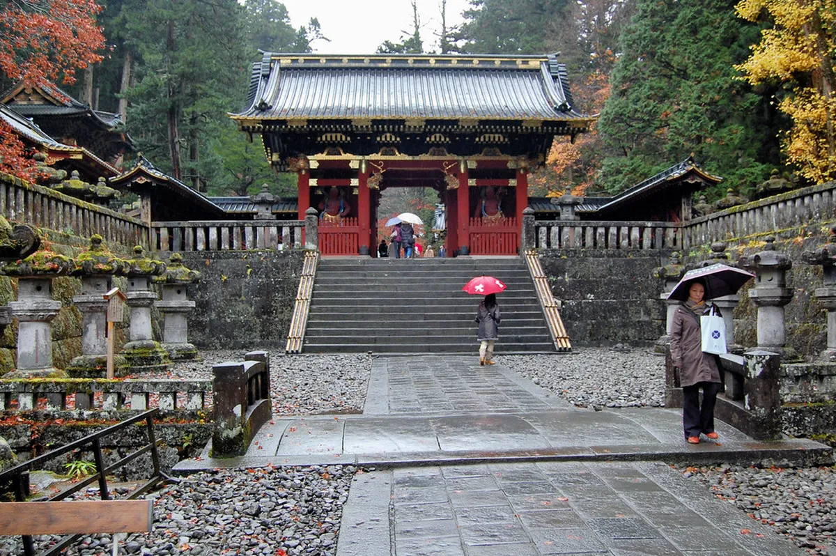 Taiyuin Mausoleum Niomon Gate in Nikko, the striking vermillion entrance guarded by fierce 3.2-meter Nio guardian statues of Tokugawa Iemitsu's mausoleum