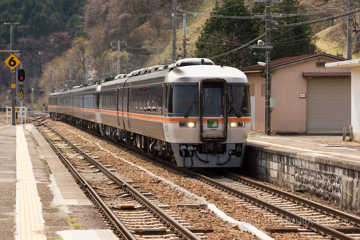 Scenic JR Hida Limited Express train winding through mountain gorges on the journey to Takayama, Japan