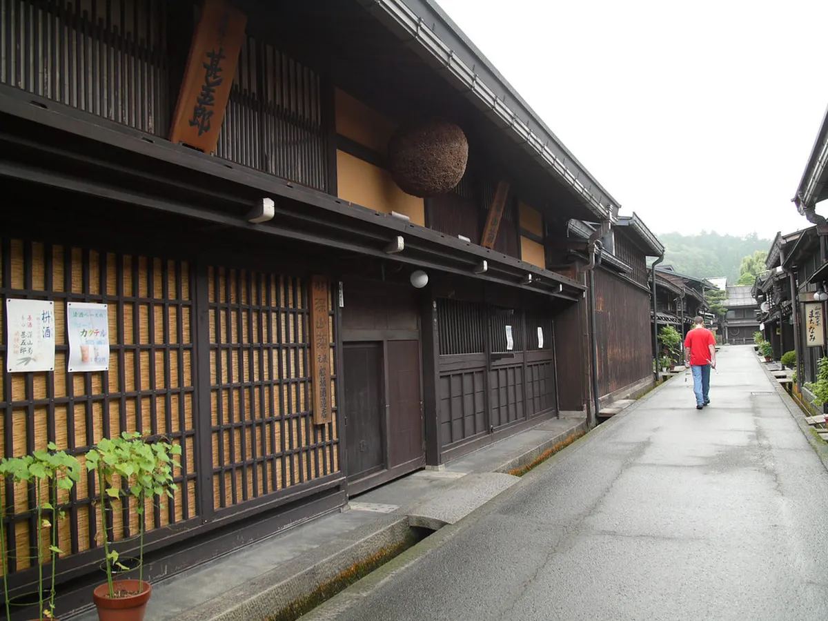 Historic sake brewery with cedar ball sugidama hanging above entrance on Sanmachi Suji in Takayama, Japan
