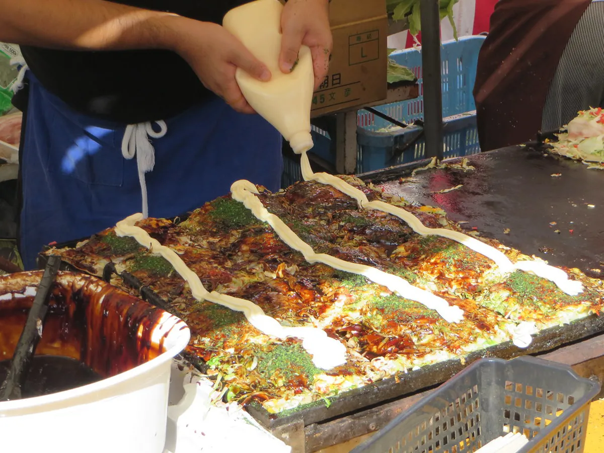 Street food vendors selling grilled skewers and snacks along Sanmachi Suji in Takayama, Japan
