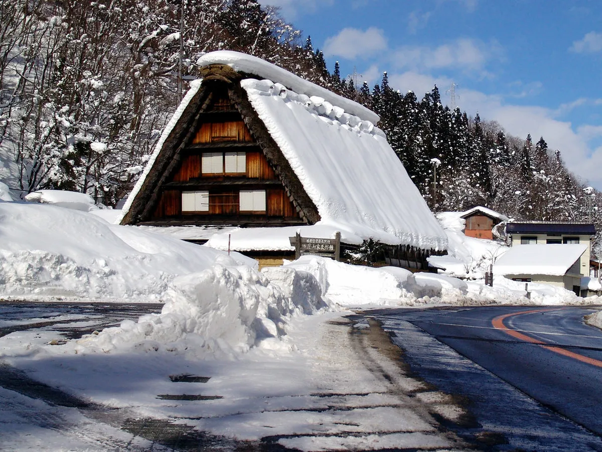 Snow-covered gassho-zukuri thatched farmhouses at Hida Folk Village in Takayama during winter, Japan
