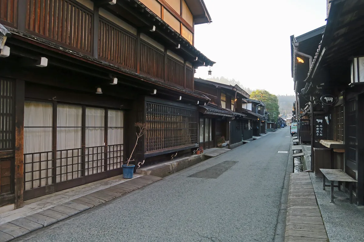 Dark wooden Edo-period merchant house facades lining the preserved lanes of Sanmachi Suji in Takayama, Japan