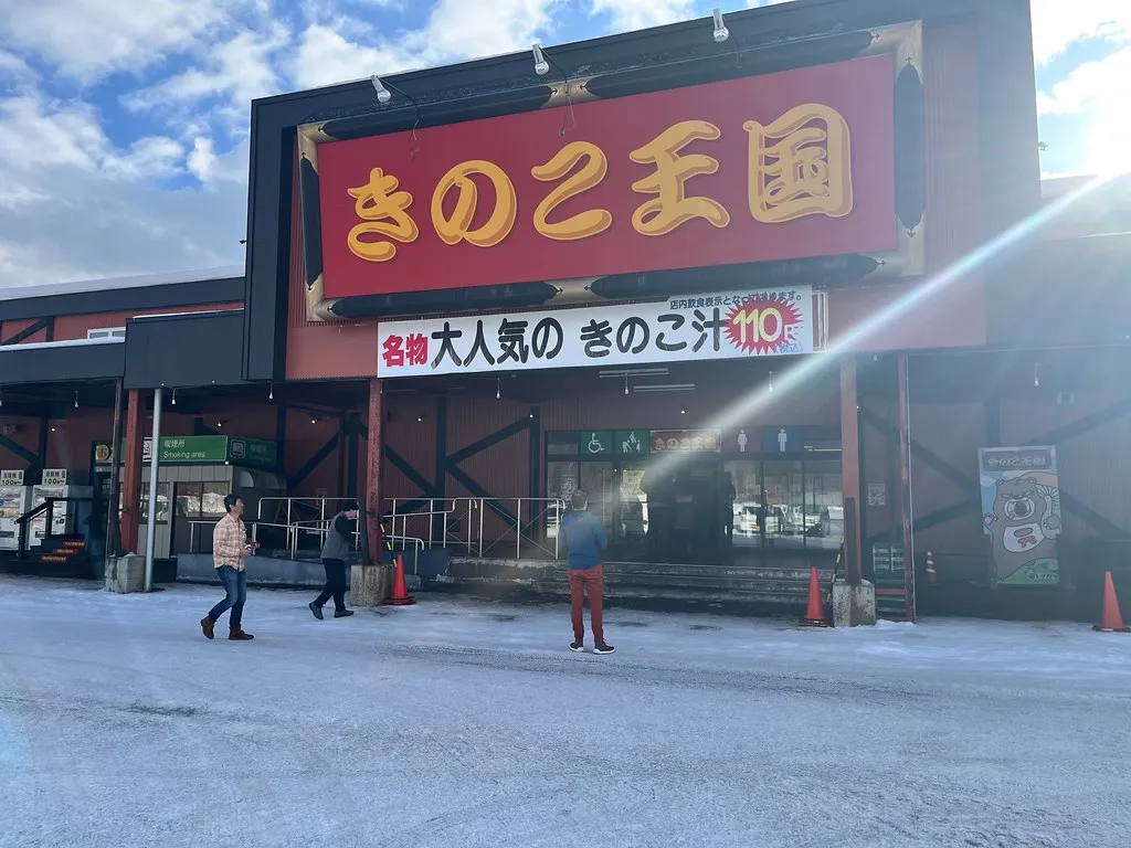 Children learning to ski in Niseko group lesson with instructor on snowy slope