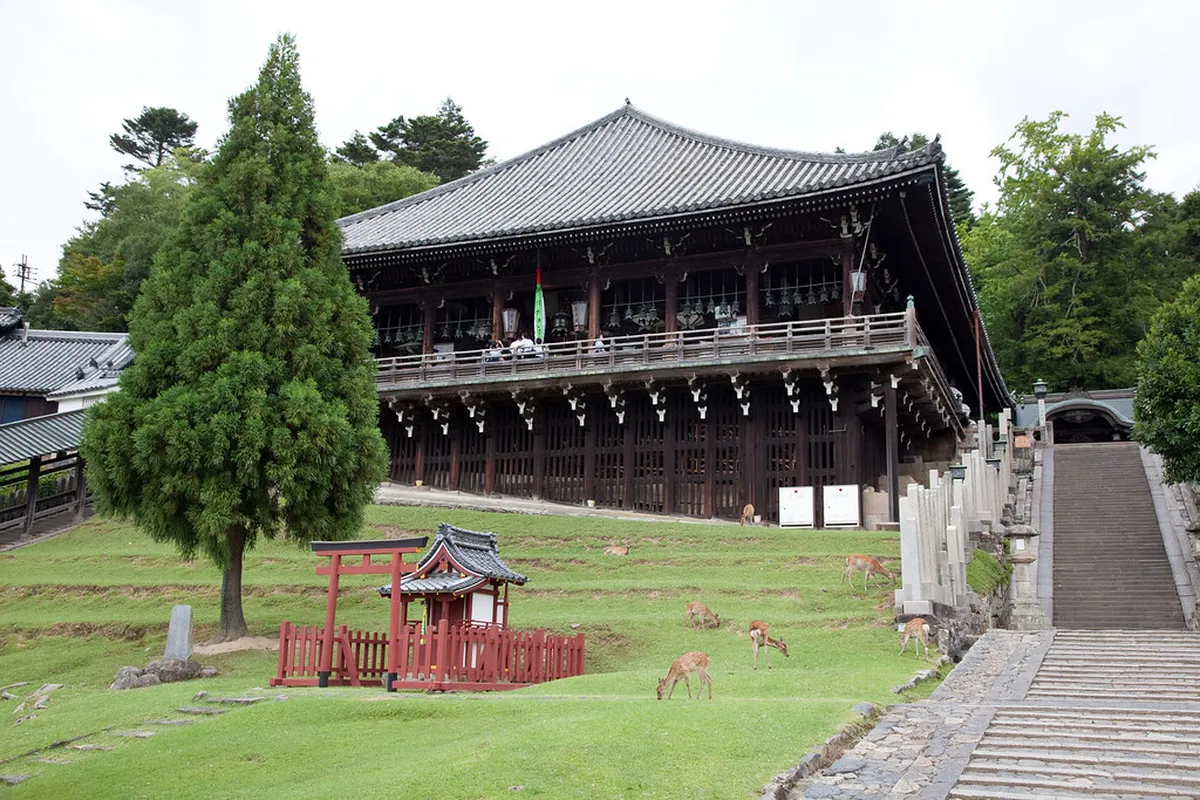 Nigatsu-do Hall wooden balcony overlooking Nara city at dusk from Todai-ji upper grounds, Japan