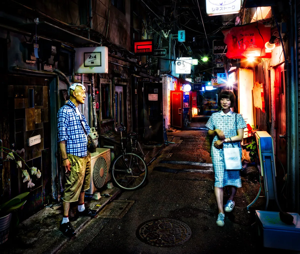 Neon signs and glowing streets of Shinjuku entertainment district at night in Tokyo, Japan
