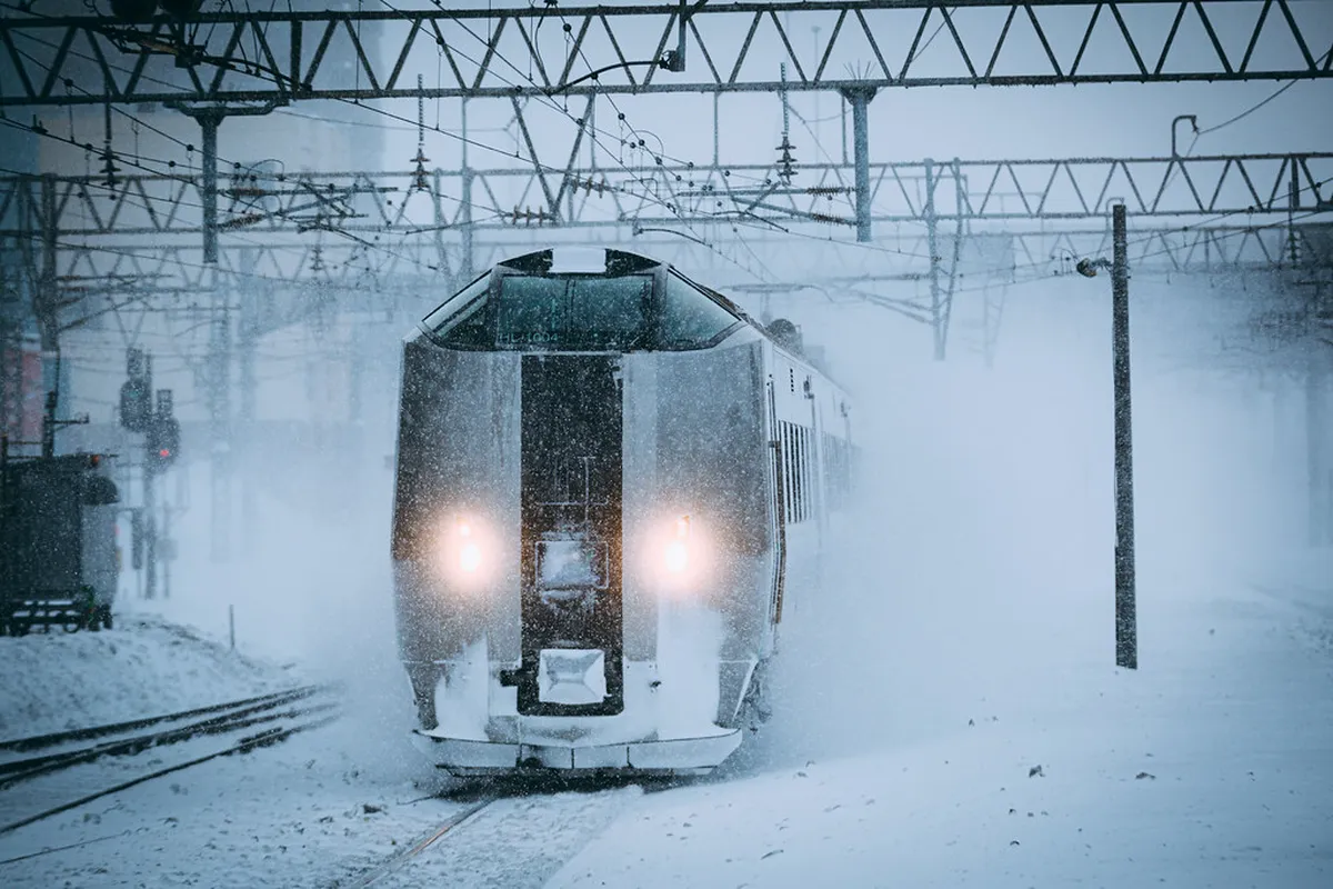 Sapporo station in Hokkaido, Japan, covered in winter snow with trains at the platform