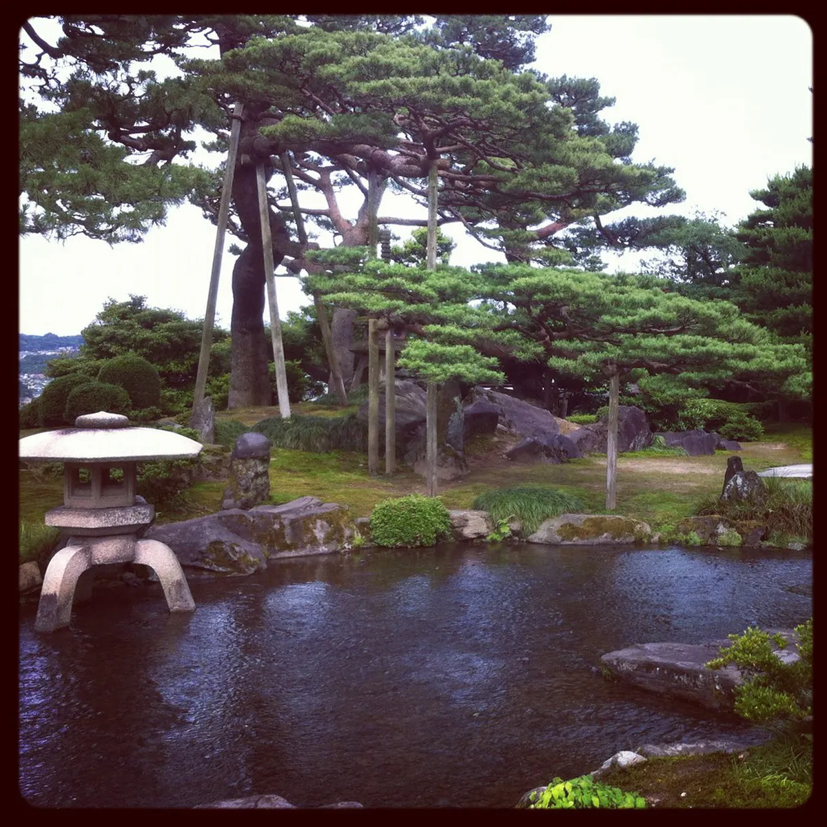 Kenrokuen Garden in Kanazawa with the iconic two-legged Kotoji stone lantern beside the pond, Japan