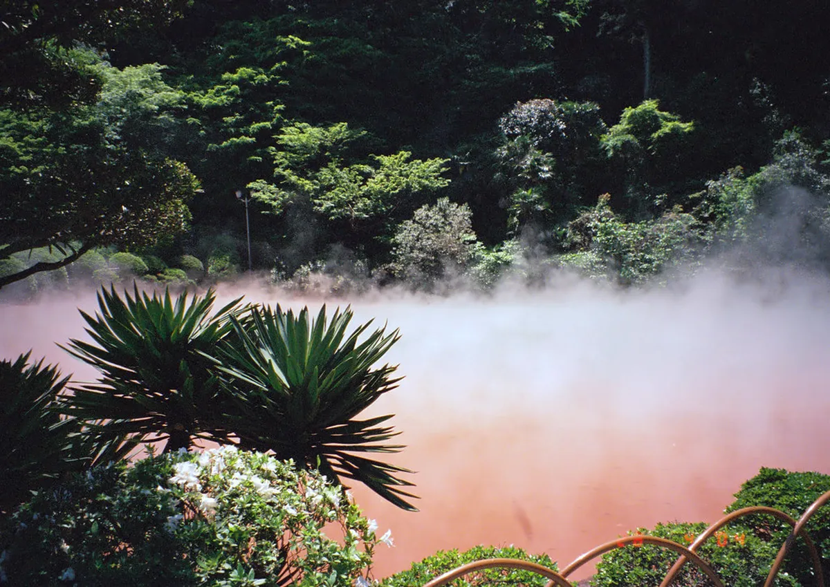 Volcanic hot spring steam rising over the geothermal landscape of Beppu, Oita, Japan