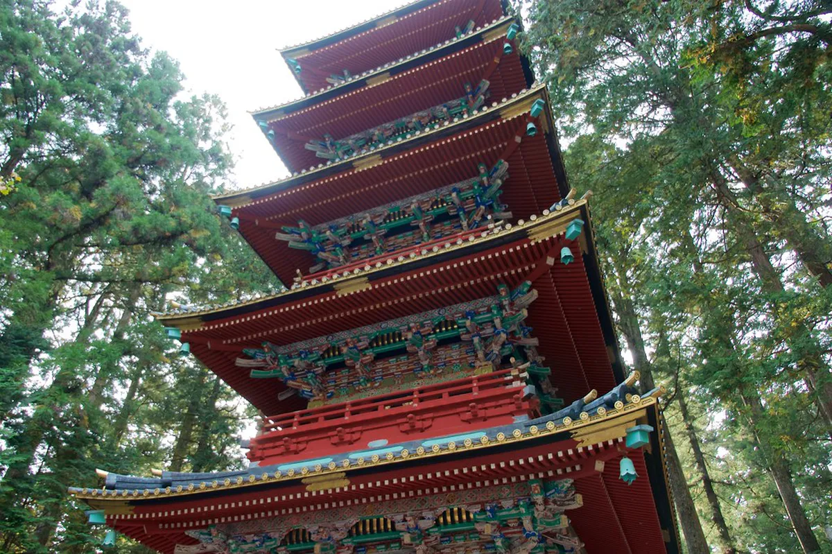 Five-story pagoda at Nikko Toshogu Shrine standing tall among the ancient cedar trees of the UNESCO World Heritage shrine complex