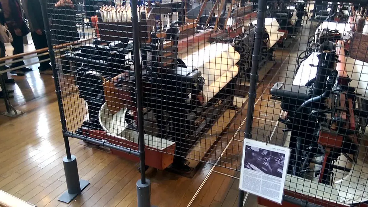 Historical textile loom machinery on display in the Toyota Commemorative Museum Nagoya pavilion, Japan