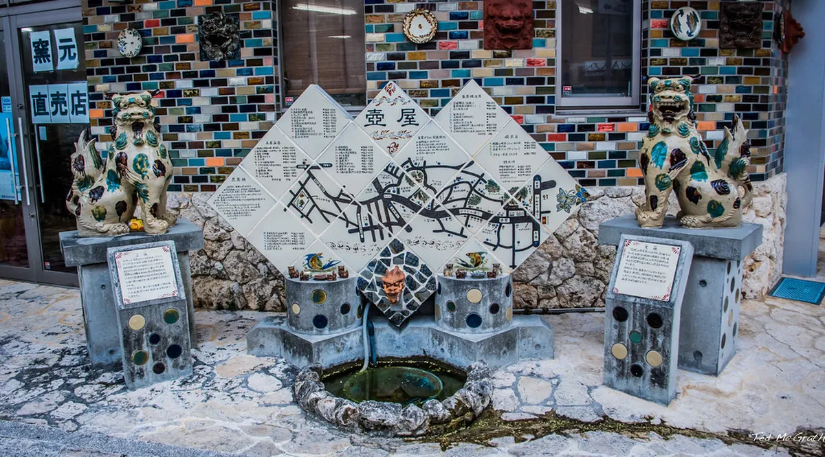 Colorful traditional Okinawan yachimun pottery displayed outside a workshop in the Tsuboya district of Naha