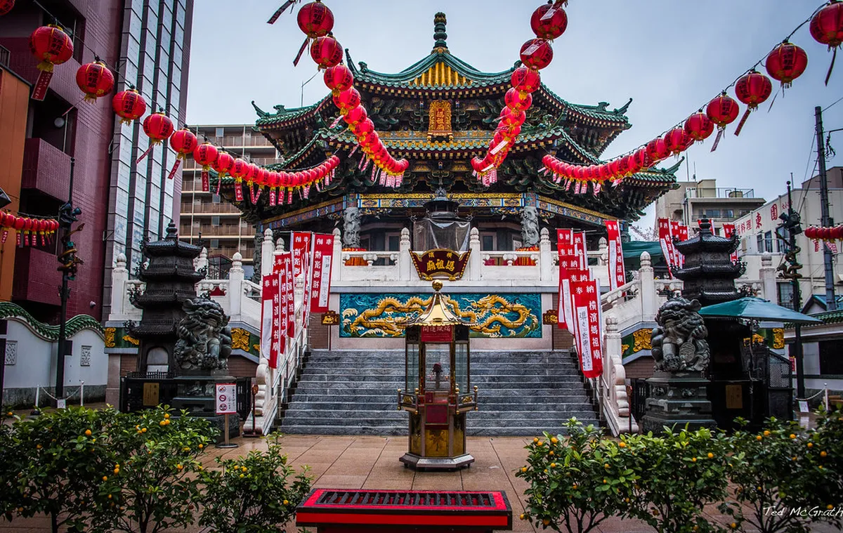 Colourful ornate Zenrin-mon gate at the entrance to Yokohama Chinatown lit up in the evening, Japan