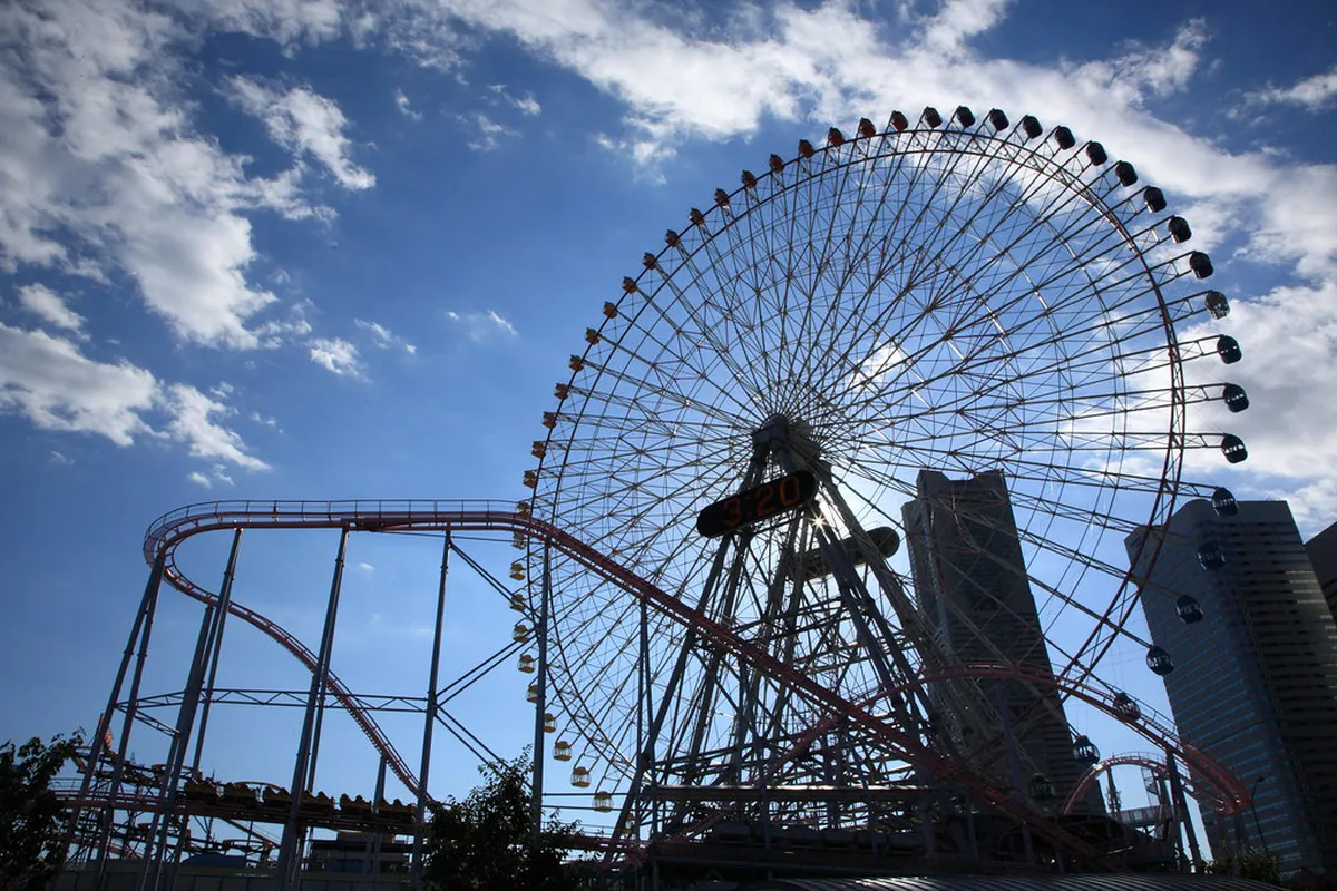 Yokohama Cosmo World amusement park with the iconic Cosmo Clock 21 Ferris wheel lit up along the harbor in Japan