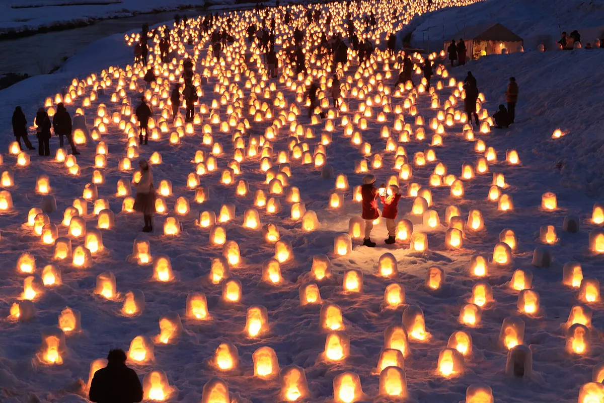 Snow kamakura huts lit at night during the Yokote Kamakura Festival, Japan — 2