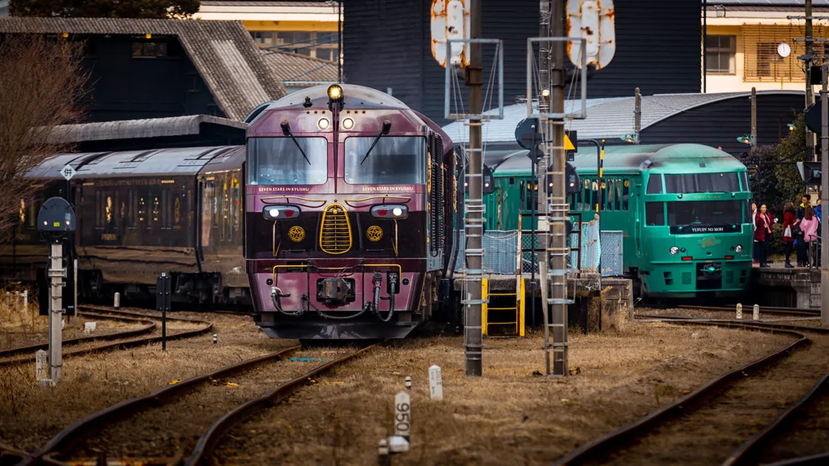 Yufuin Station in Oita Prefecture with the scenic mountain valley backdrop and clear skies in Kyushu Japan