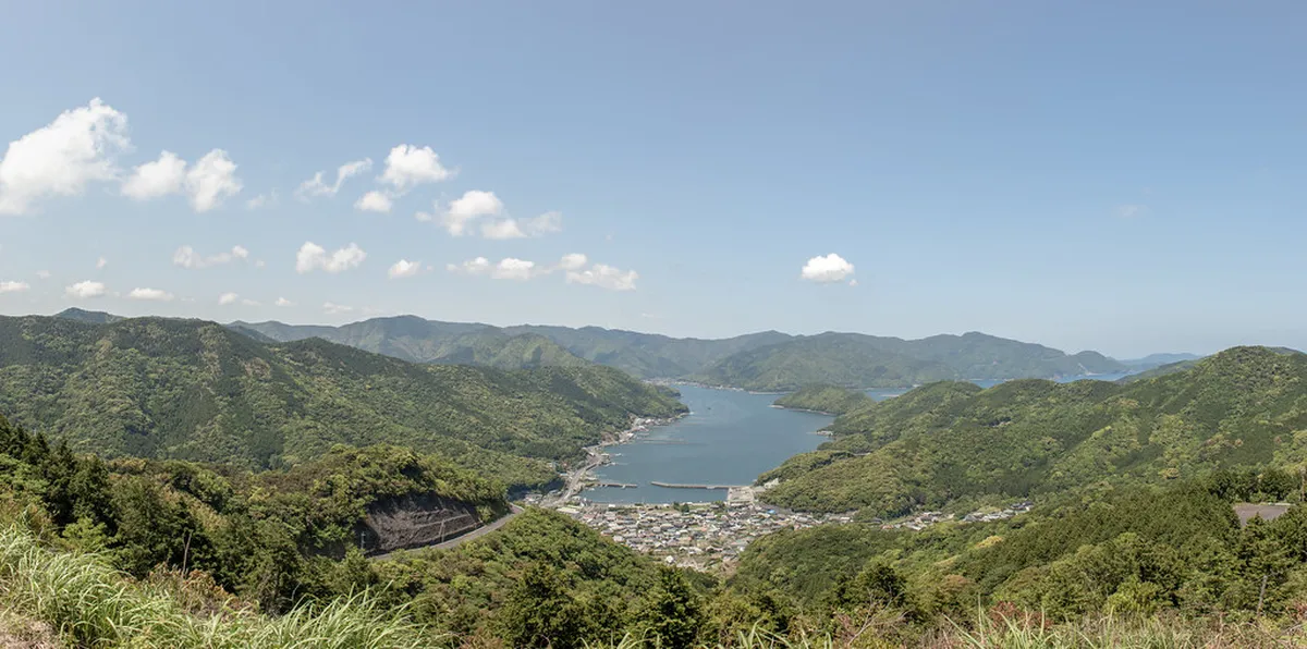 Oita Kyushu mountain valley with lush green hills and traditional scenery surrounding the Yufuin onsen town in Japan