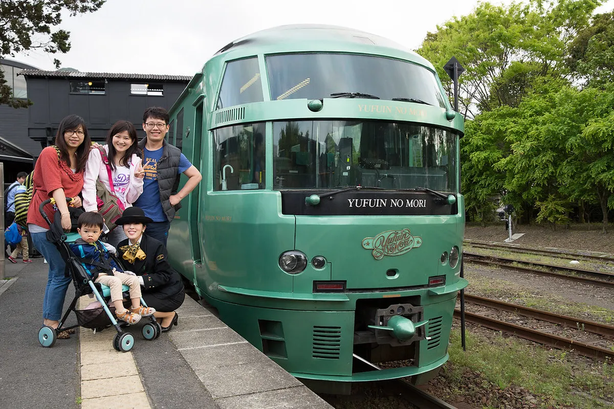 Interior of the Yufuin no Mori sightseeing train with wooden decor and panoramic windows in Japan
