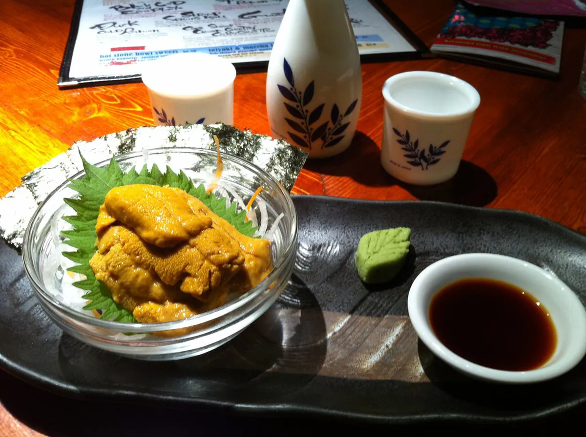 Hot freshly fried croquettes and street food snacks sold at a vendor stall in Yufuin Japan
